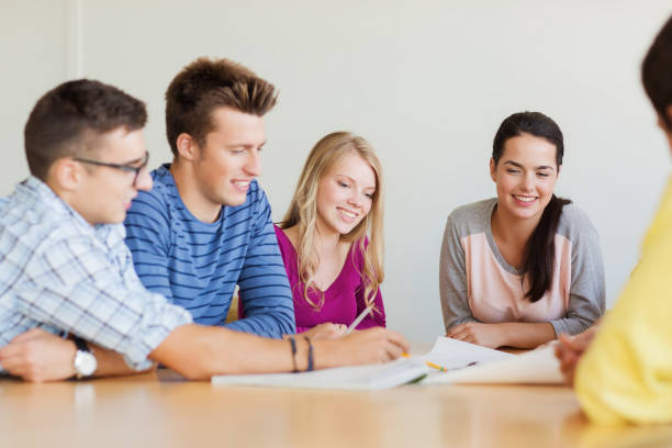 istock group of smiling students with blueprint 1314489867