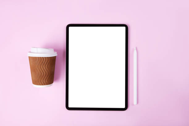 tablet computer pro with white screen on pink color background. Flatlay. Office background