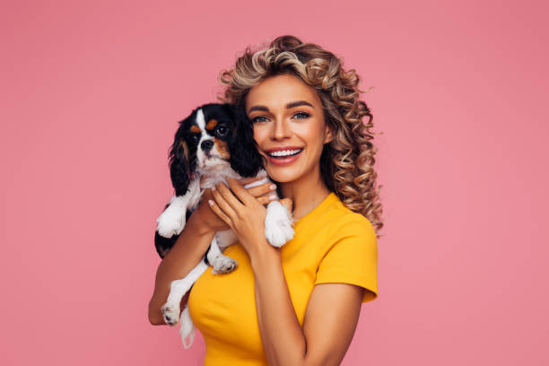 istock Studio Portrait Of Smiling Young Woman Holding Affectionate Pet 1314491161