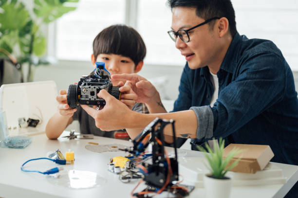 istock Optimistic Asian father and son enjoying their robotic hobby 1314491618