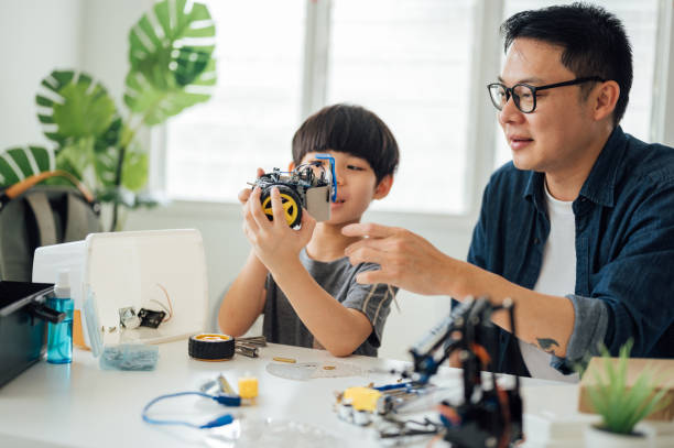 istock Optimistic Asian father and son enjoying their robotic hobby 1314491698