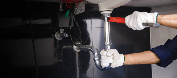 istock Plumber fixing white sink pipe with adjustable wrench. 1314491764