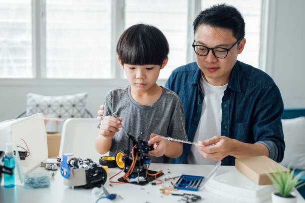 istock Optimistic Asian father and son enjoying their robotic hobby 1314491786