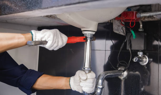 istock Plumber fixing white sink pipe with adjustable wrench. 1314491797