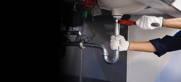 istock Plumber fixing white sink pipe with adjustable wrench. 1314491798