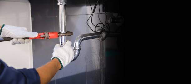 istock Plumber fixing white sink pipe with adjustable wrench. 1314491817