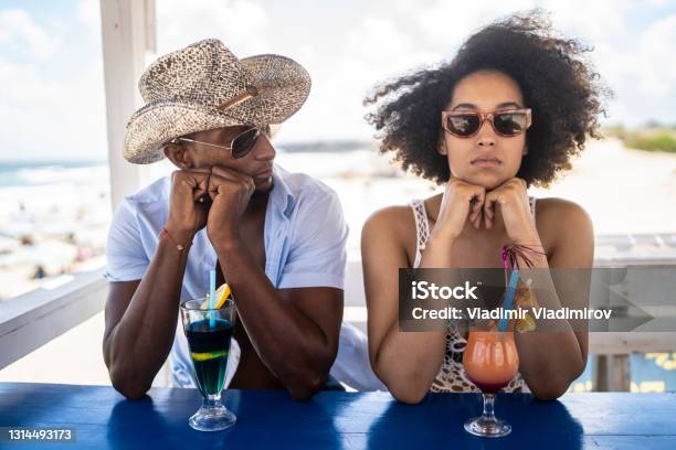 Young Afro Couple Having Arguments In Their Holiday On The Beach Stock Photo - Download Image Now