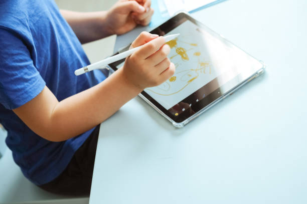 istock Hands of Children drawing with digital pen on the tablet, image with copy space. 1314493532