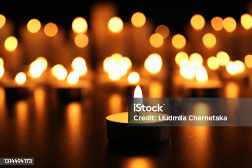 istock Burning candle on black table. Memory day 1314494173
