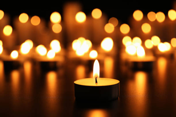 Burning Candle On Black Table Memory Day Stock Photo - Download