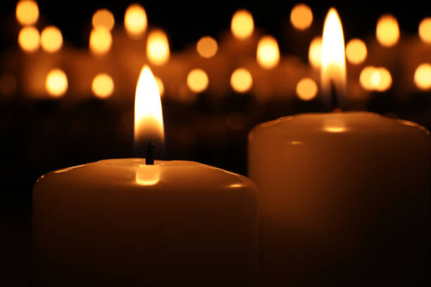 istock Burning candles in darkness, closeup. Memory day 1314494218