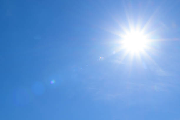 istock Bright sun in blue sky. Halo effect 1314495701