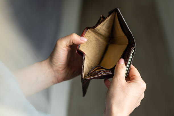 istock Woman holding an empty wallet 1314495826