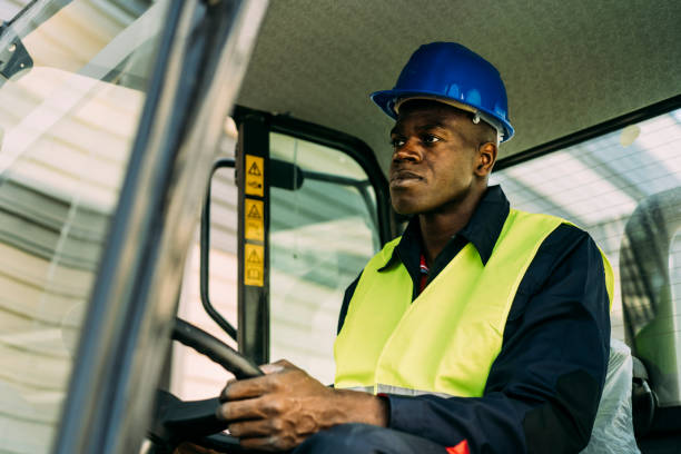 istock Afro-American worker driving bulldozer 1314495899