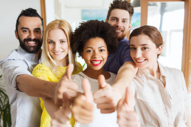 istock happy creative team showing thumbs up in office 1314496141