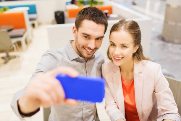 istock happy couple taking selfie with smartphone in cafe 1314496656