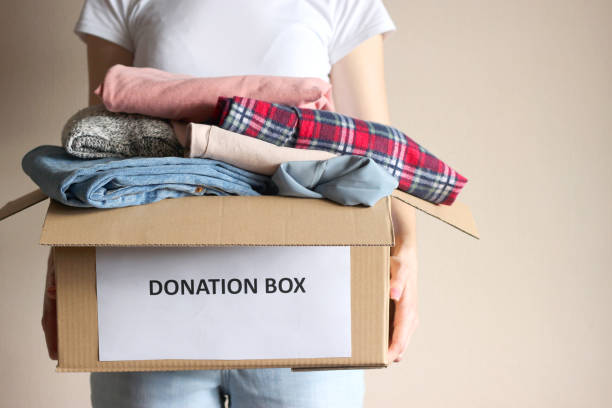 istock girl holding a box with donations 1314496851