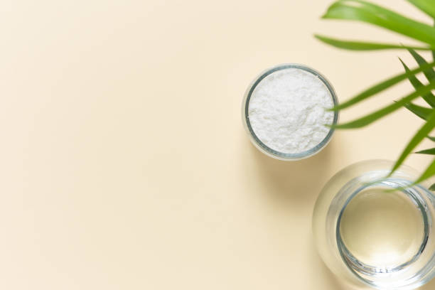 istock Collagen powder and a glass of water on a beige background with a copy space. Extra protein intake 1314497607