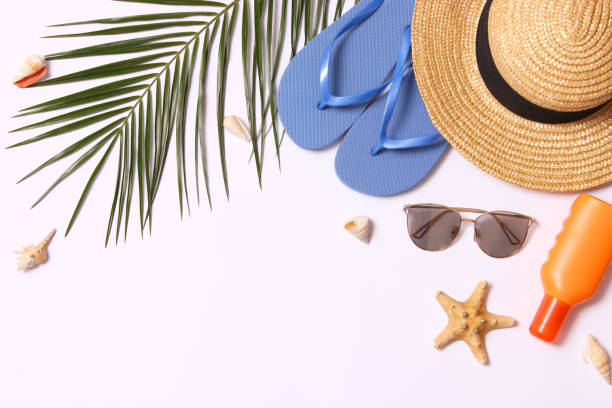 istock travel accessories and tropical leaves on a colored background top view. 1314497649