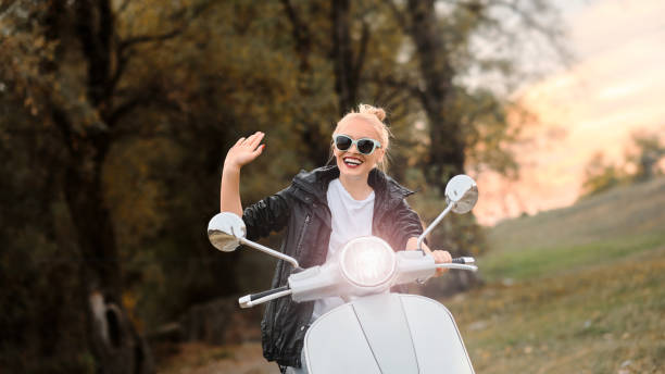 istock A young and beautiful blonde rides a scooter. 1314497656