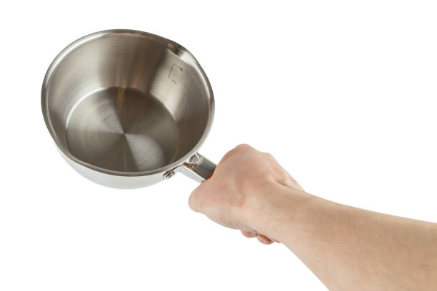 istock bare caucasian hand holding small shiny stainless steel pot - isolated on white 1314498088