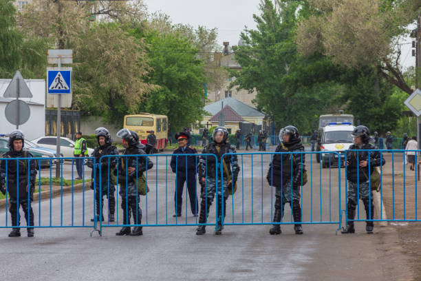 riot policemen behind fences during a rally in Kazakhstan against the sale of land Uralsk, Kazakhstan (Qazaqstan), 21.05.2016: riot policemen behind fences during a rally in Kazakhstan against the sale of land, the closure of the city center during a rally, a rally in Uralsk agains kazakhstan photos stock pictures, royalty-free photos & images