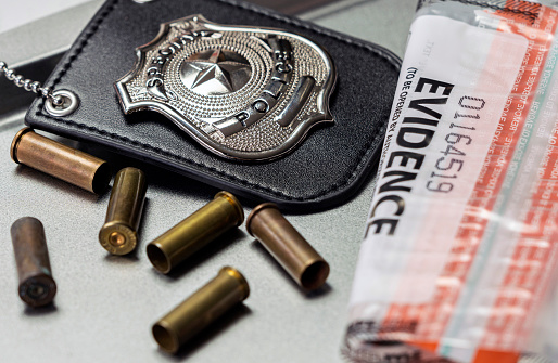 Police badge next to bullets, concept image