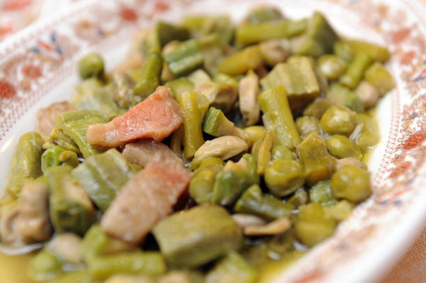 vignarola is a typical dish of the lazio region and typical food from rome area based on roman artichokes, peas, broad beans, asparagus and other fresh spring vegetables - broad bean imagens e fotografias de stock