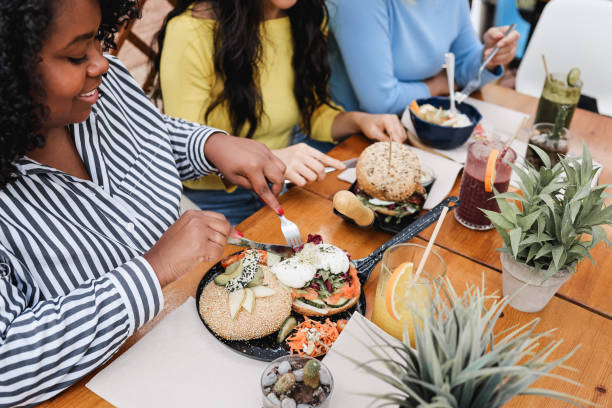 istock Young multiracial friends having breakfast outdoors in restaurant terrace - Focus on african girl right hand 1314505167
