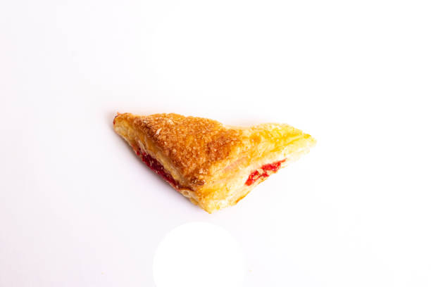 Puff pastry with berry jam isolated on white background close up