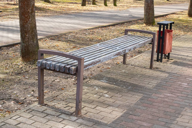 istock Bench and trash can in the park 1314505362
