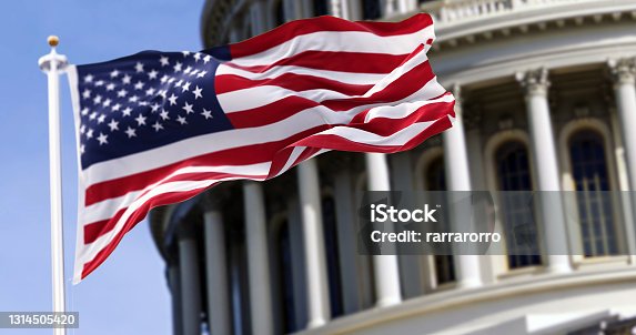 istock The flag of the united states of america flying in front of the capitol building blurred in the background 1314505420