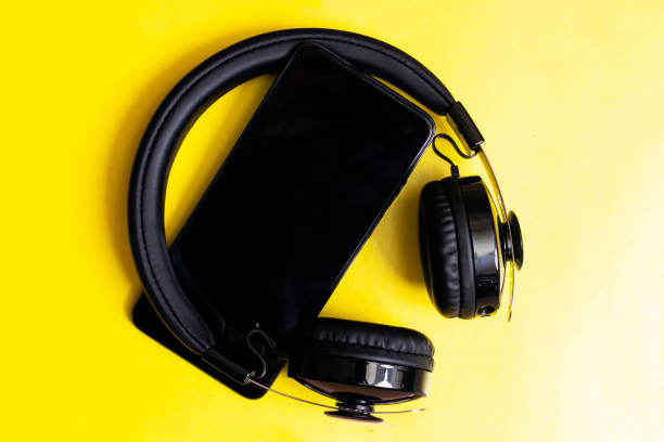 istock Headphones and phone on a yellow background 1314505521