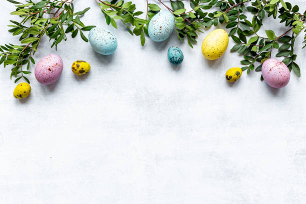 istock Happy Easter card with colorful eggs and green leaves. Overhead view 1314506872