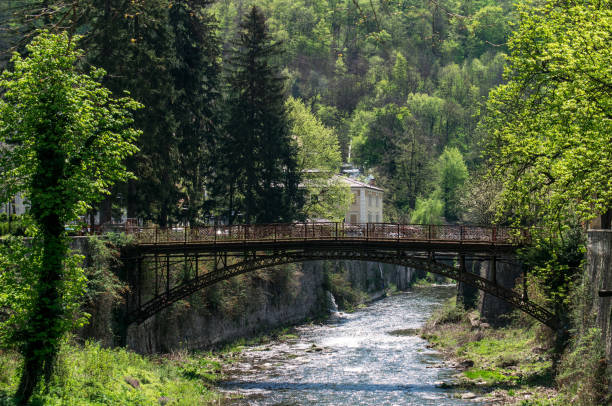 istock Old wrought iron bridge over a mountain river. 1314507567