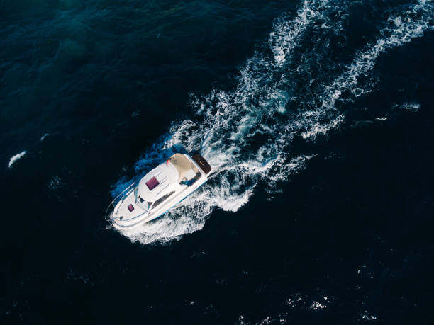 istock White motorboat floats on the open sea. View from above 1314507677