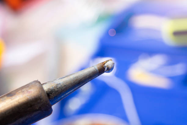 Soldering iron tip and yellow rosin close up