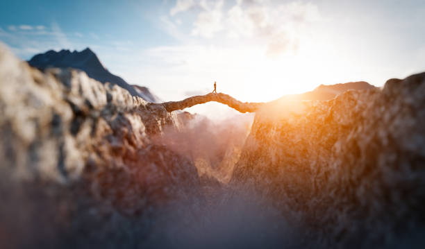 istock Man walking on the other side of mountain bridge. 1314508112