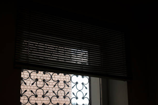 Blinds on the window in a dark room close up