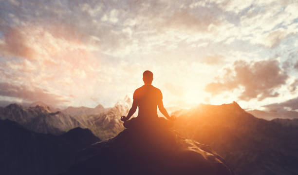 istock Man in yoga pose, zen meditation at sunset. 1314509770