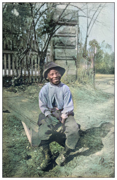 Antique colorized photo of the United States: Happy boy Antique colorized photo of the United States: Happy boy black culture photos stock illustrations
