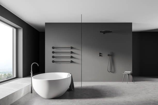 istock Grey bathroom interior with shower, bathtub on concrete floor 1314511436