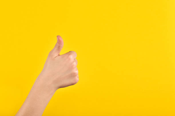 istock Childrens hands showing okay gesture on yellow background. Communication without words. Excellent 1314512660