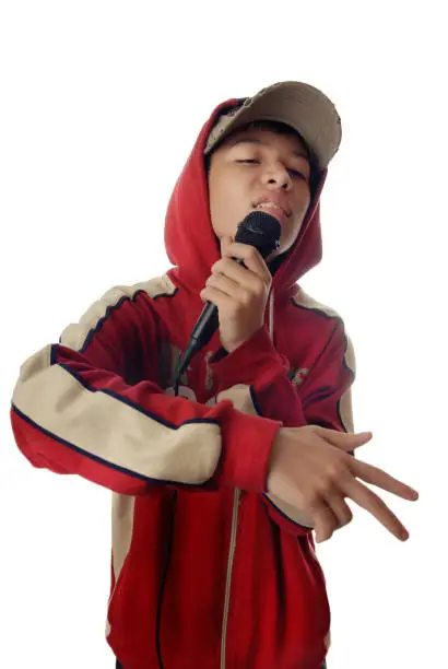 Photo of Young boy in rapper clothes singing a hip-hop