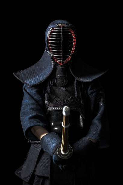 Portrait of kendo fighter Japanese kendo fighter with with shinai on a black background kendo stock pictures, royalty-free photos & images
