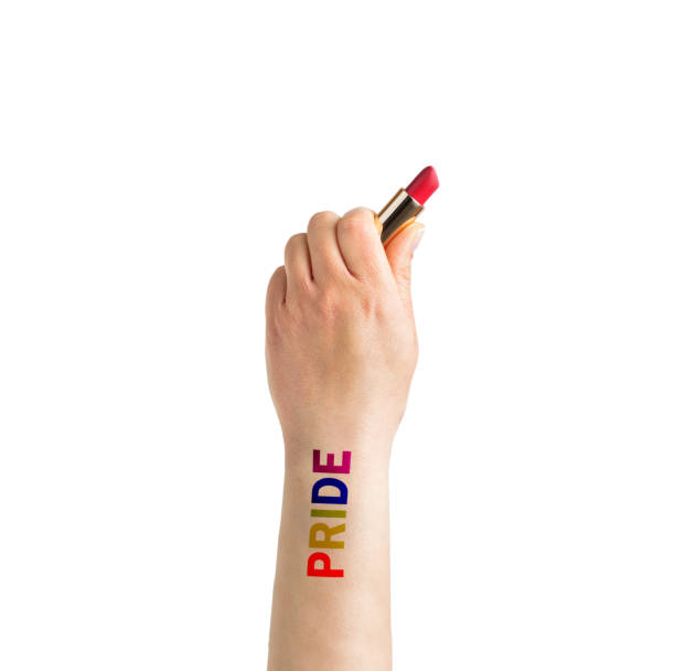 Gay guy's hand with a tattoo that says pride holding a lipstick Gay guy's hand with a tattoo that says pride holding a lipstick. Symbol of sexual liberation and tolerance arm tattoo ideas for men pictures stock pictures, royalty-free photos & images