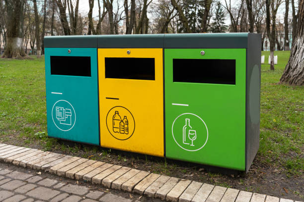 istock waste sorting containers. separate waste bins for glass, plastic and paper. Waste sorting, three colorful bins with symbols 1314517978