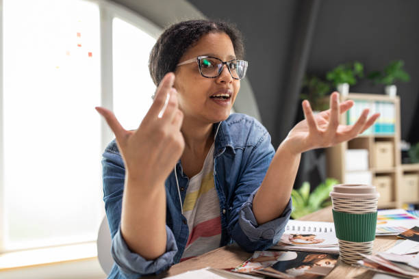 istock Female photographer gesturing while video chatting with a client 1314518016