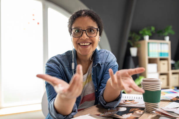istock Cheerful female photographer video chatting with a client and gesturing with hands 1314518090