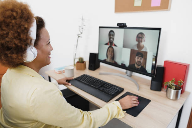 istock African woman having video call with her colleagues using computer app - Soft focus on right hand 1314518486